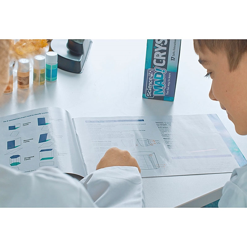 Science Mad Crystal Growing Lab Girl and Boy looking through Experiments Instruction Manual